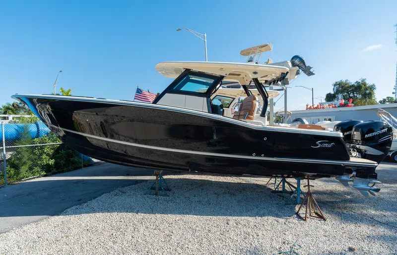 The Image of 2025 Scout 330 LXF boat on display with dual Mercury engines. - 0