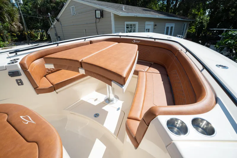 Slide: The Image of Luxurious seating area on the 2025 Scout 330 LXF boat with tan leather upholstery. - 16