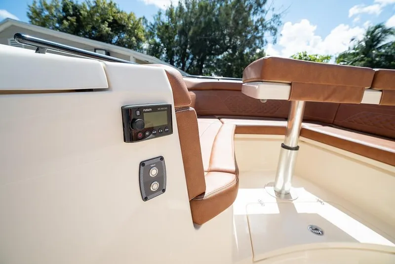 Slide: The Image of 2025 Scout 330 LXF boat interior with brown leather seating and control panel. - 19