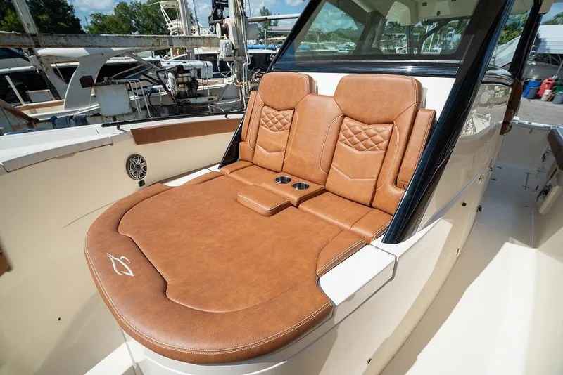 Slide: The Image of Luxurious seating on the 2025 Scout 330 LXF boat with tan leather upholstery. - 21