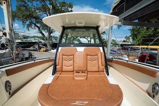 Slide: The Image of 2025 Scout 330 LXF boat with luxurious tan seating and modern design. - 22