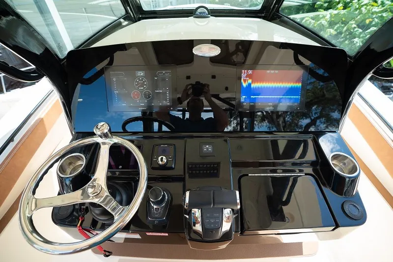 Slide: The Image of Helm of 2025 Scout 330 LXF boat with modern controls and digital displays. - 25