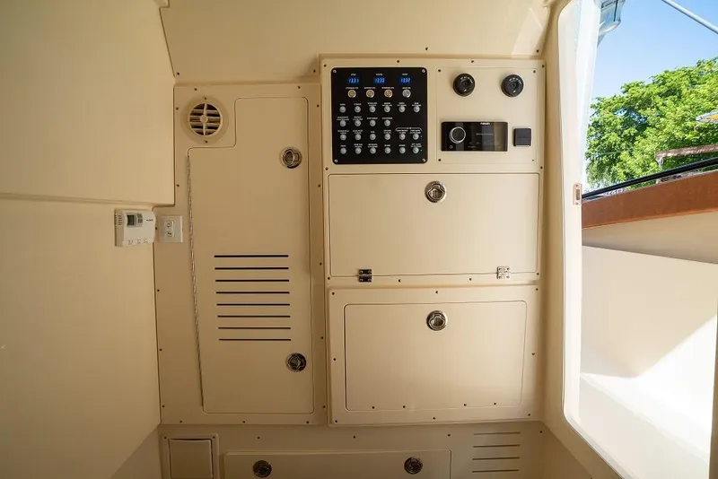 Slide: The Image of Control panel and storage compartments on the 2025 Scout 330 LXF boat. - 26