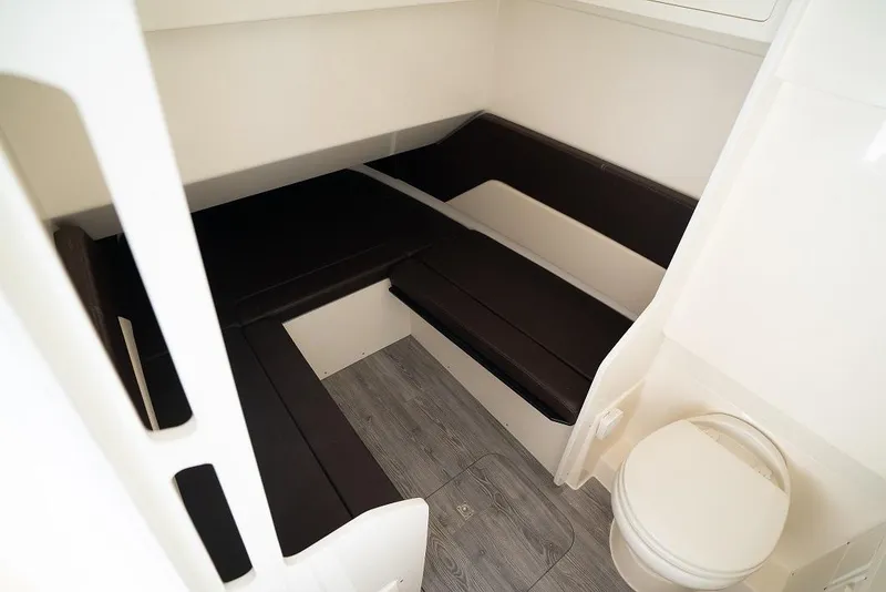 Slide: The Image of 2025 Scout 330 LXF cabin interior with seating and toilet. - 28