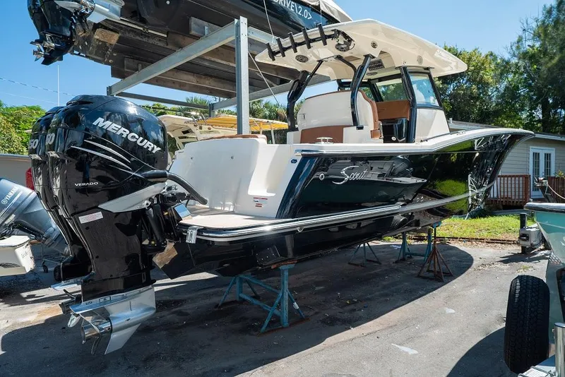 Slide: The Image of 2025 Scout 330 LXF boat with twin Mercury Verado engines on display. - 3