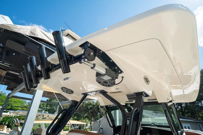 Slide: The Image of 2025 Scout 330 LXF boat with advanced fishing rod holders and electronic equipment. - 35