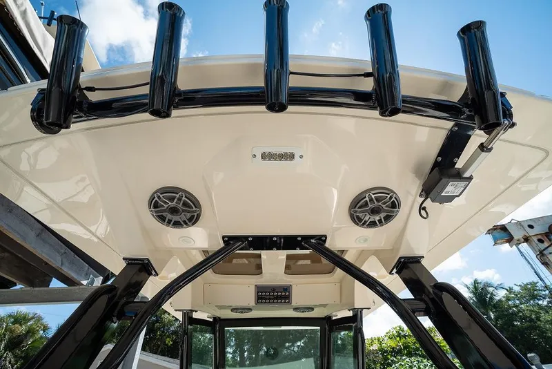 Slide: The Image of 2025 Scout 330 LXF boat roof with rod holders and speakers. - 36