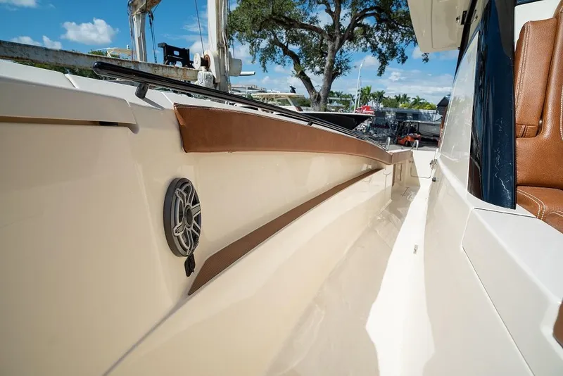 Slide: The Image of 2025 Scout 330 LXF boat interior with speaker and brown trim. - 39