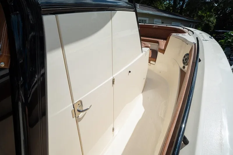 Slide: The Image of 2025 Scout 330 LXF boat interior with beige seating and storage compartments. - 40
