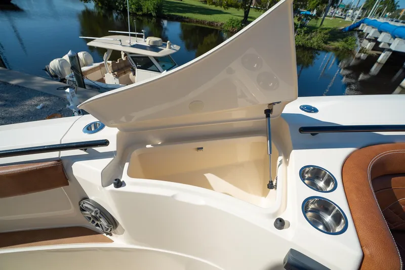 Slide: The Image of Open storage compartment on a 2025 Scout 330 LXF boat, docked near water. - 45