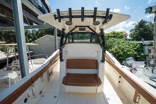 Slide: The Image of 2025 Scout 330 LXF boat interior with seating and T-top. - 5
