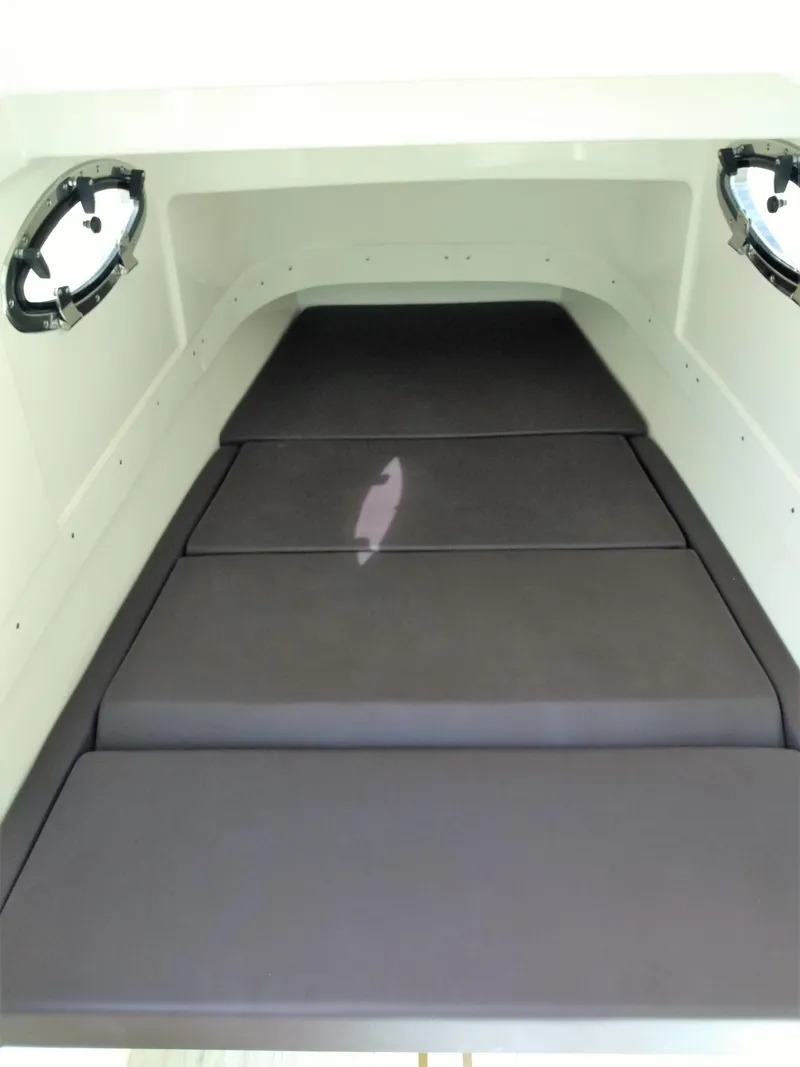 Slide: The Image of Interior cabin of 2025 Scout 305 LXF boat with cushioned seating. - 10