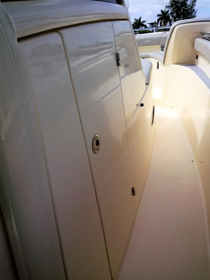 Slide: The Image of 2025 Scout 305 LXF boat interior, showing sleek storage compartments and seating area. - 17