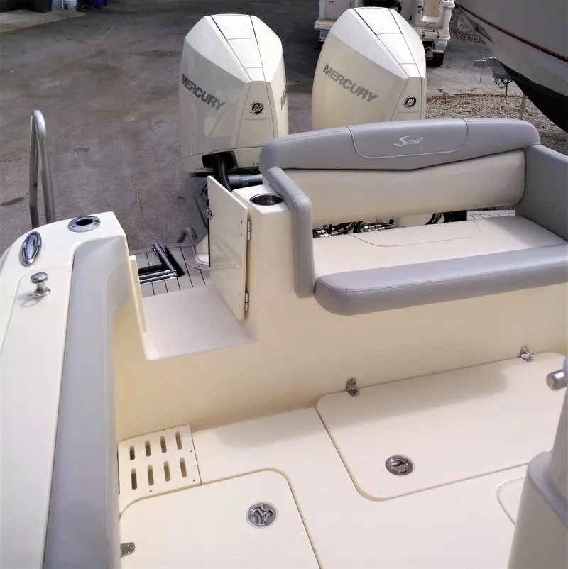 Slide: The Image of 2025 Scout 305 LXF boat with twin Mercury engines, rear seating, and storage compartments. - 18