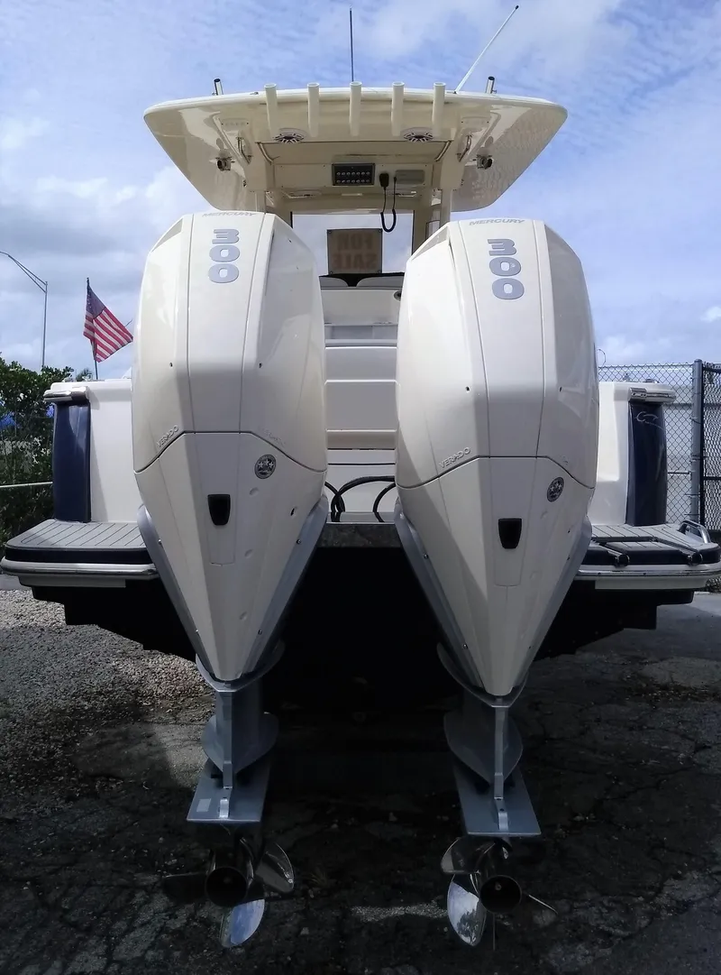 Slide: The Image of 2025 Scout 305 LXF boat with twin Mercury 300 outboard engines. - 2