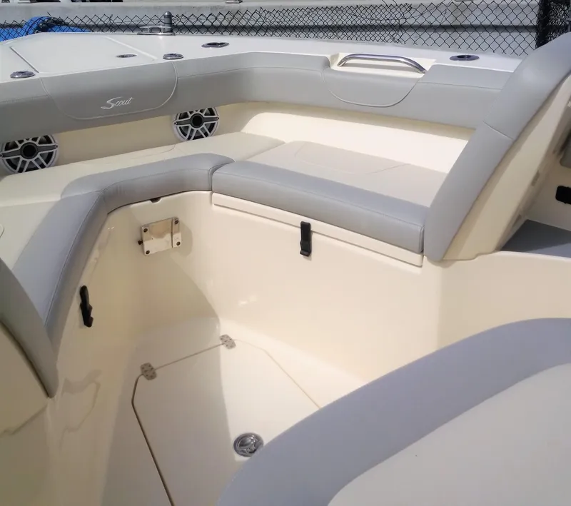 Slide: The Image of 2025 Scout 305 LXF boat interior with cushioned seating and storage compartments. - 3