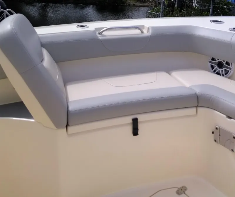 Slide: The Image of 2025 Scout 305 LXF boat interior seating with gray and white upholstery. - 6
