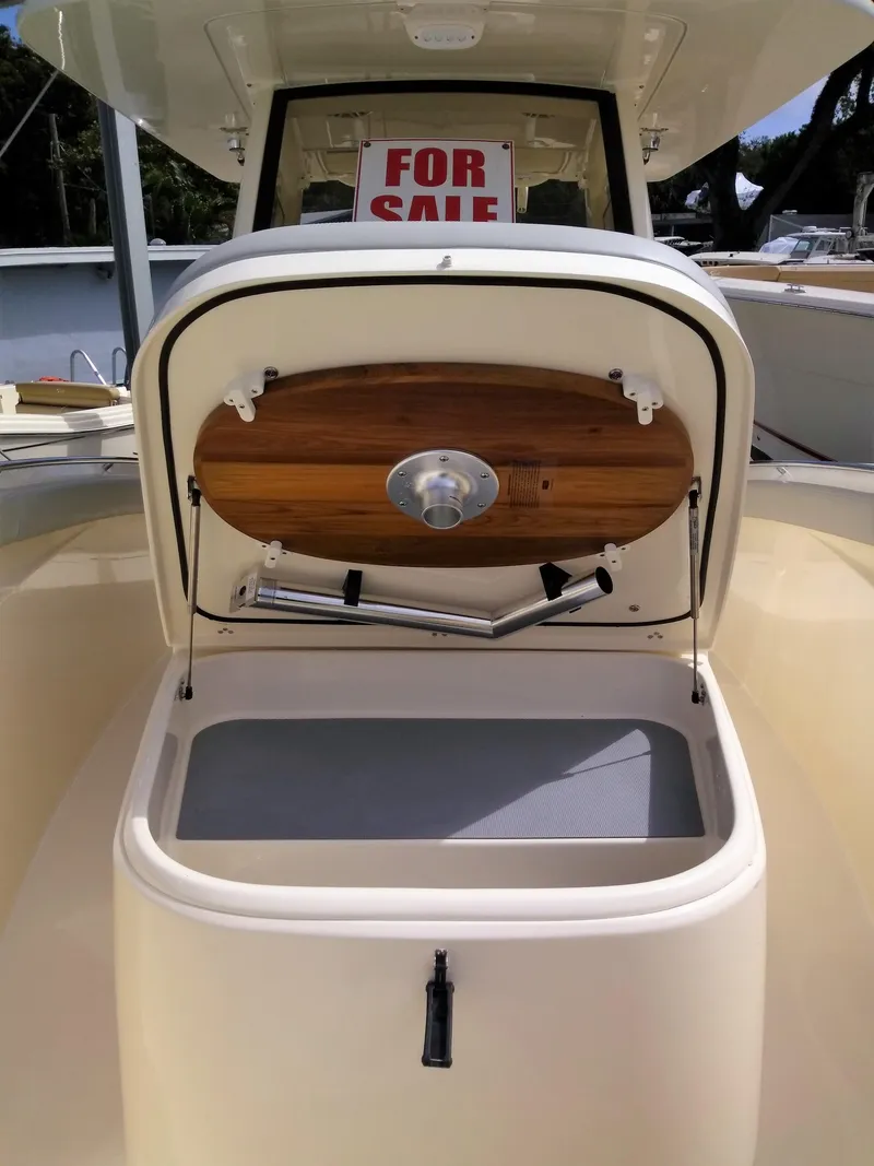 Slide: The Image of 2025 Scout 305 LXF boat for sale, open storage compartment. - 7
