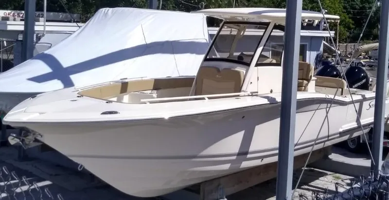 The Image of 2025 Scout 277 LXF boat in marina, side view. - 0