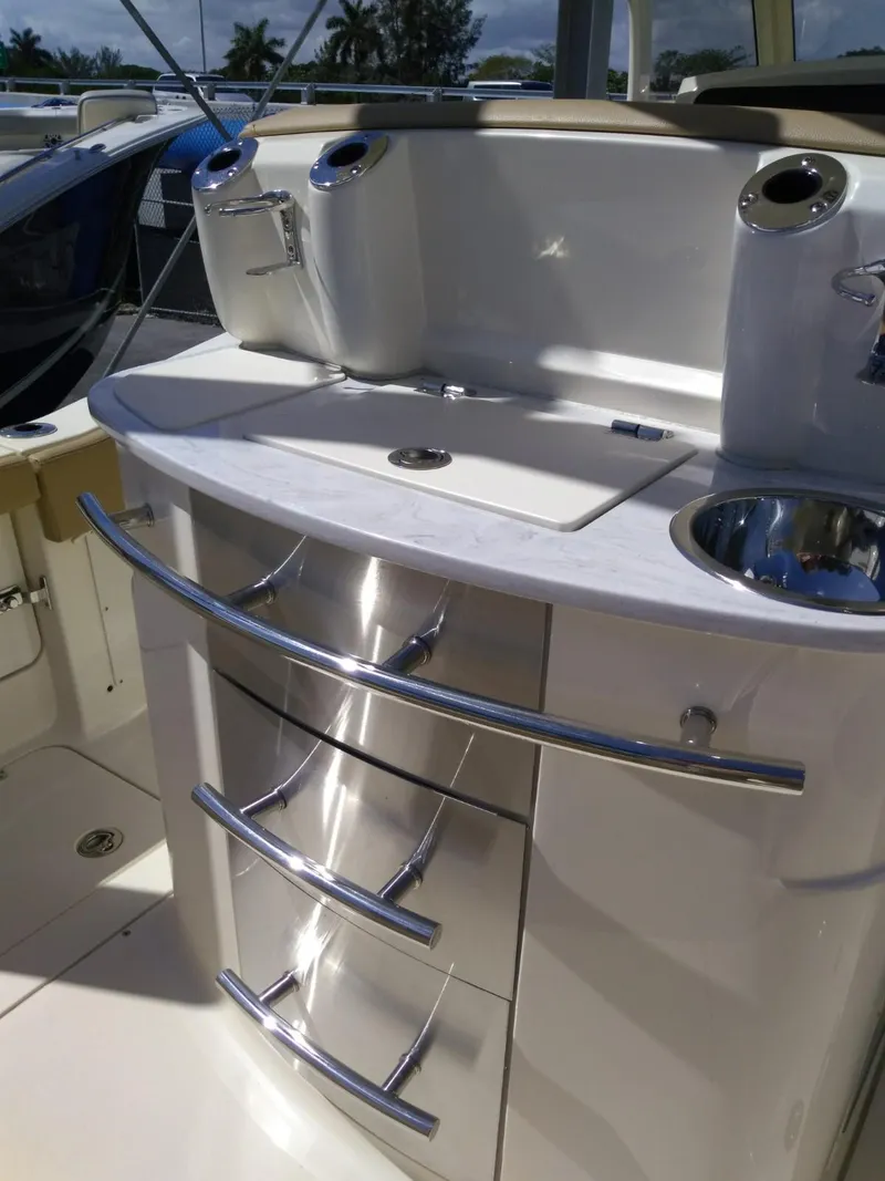 Slide: The Image of 2025 Scout 277 LXF boat interior with stainless steel drawers and sink. - 10