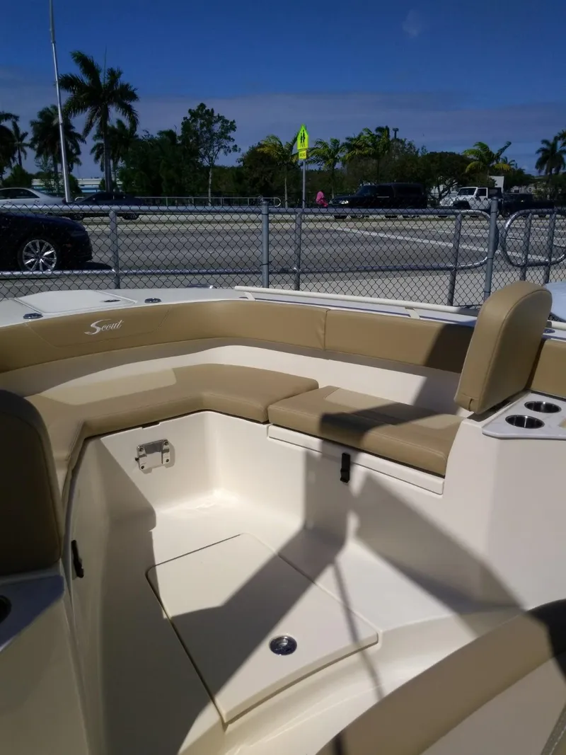 Slide: The Image of 2025 Scout 277 LXF boat interior with tan seating and cup holders. - 12