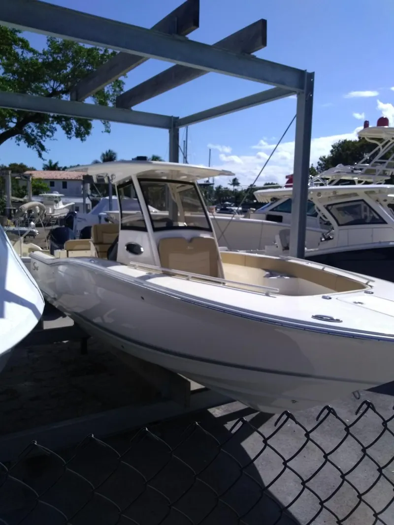 Slide: The Image of 2025 Scout 277 LXF boat on display at a marina. - 18