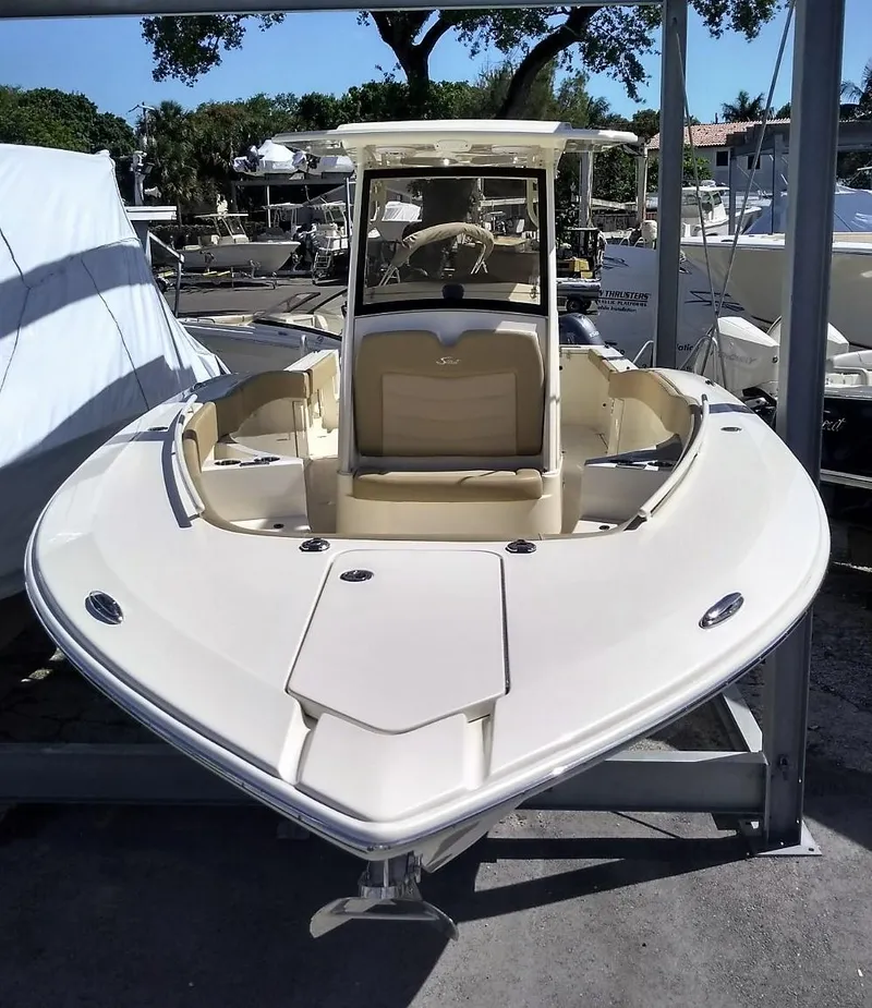 Slide: The Image of 2025 Scout 277 LXF boat docked at a marina. - 19