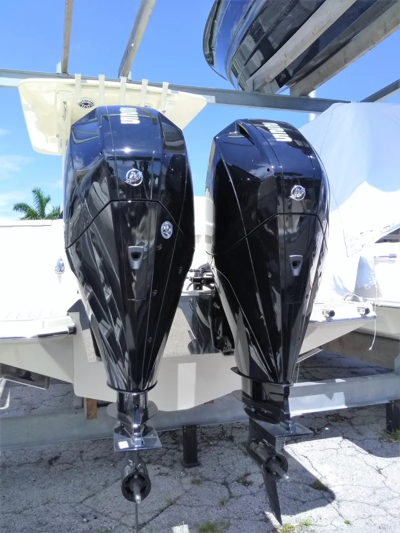 Slide: The Image of 2025 Scout 277 LXF boat with dual outboard engines. - 2