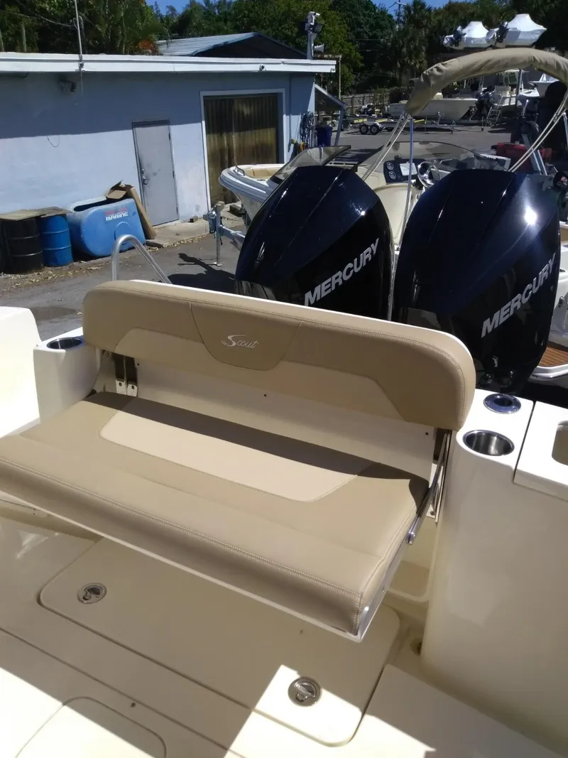Slide: The Image of 2025 Scout 277 LXF boat with dual Mercury engines and beige seating. - 9
