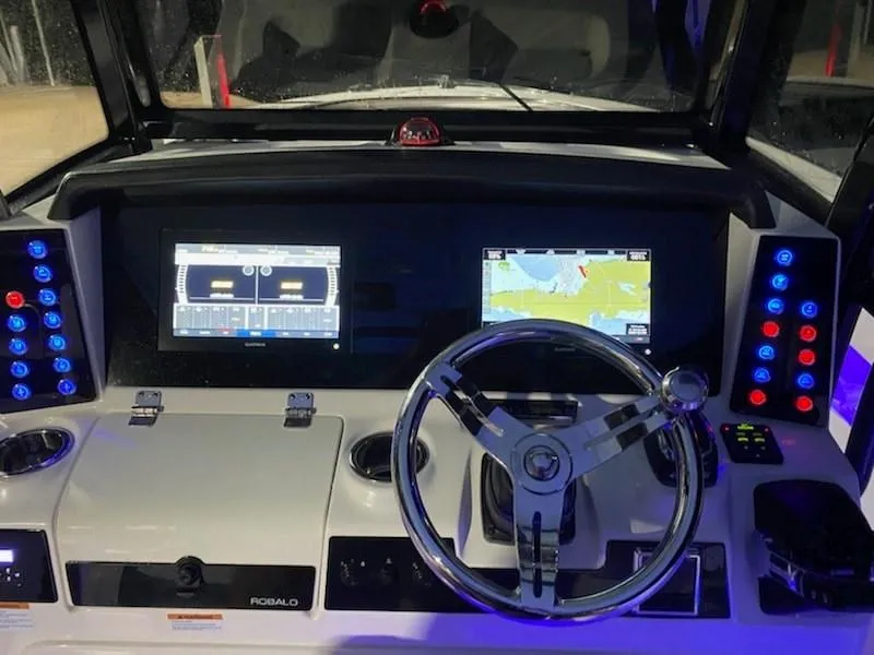 Slide: The Image of 2020 Robalo 302 boat dashboard with navigation screens and controls. - 3