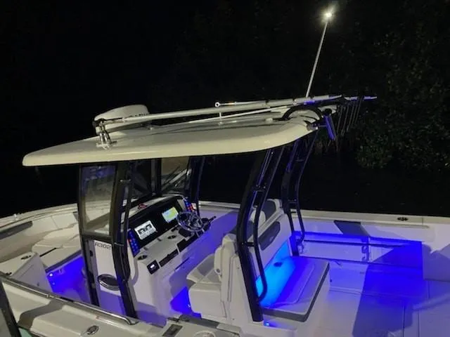 Slide: The Image of 2020 Robalo 302 boat with illuminated interior at night. - 5
