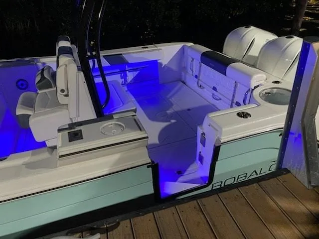 Slide: The Image of 2020 Robalo 302 boat interior with blue LED lighting at night. - 8