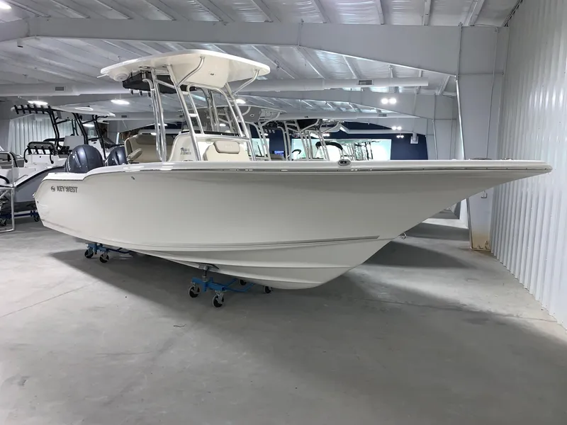 Slide: The Image of 2024 Key West 244 Center Console boat in indoor showroom. - 1
