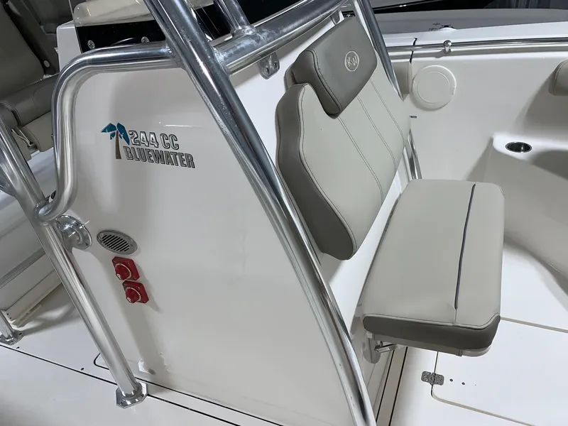 Slide: The Image of 2024 Key West 244 Center Console boat interior with cushioned seating and stainless steel frame. - 14