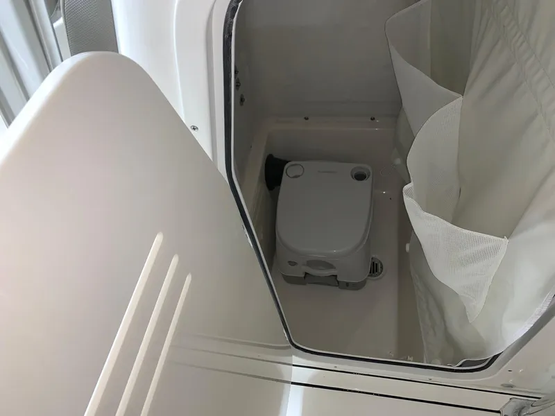 Slide: The Image of 2024 Key West 244 Center Console boat interior with portable toilet. - 15