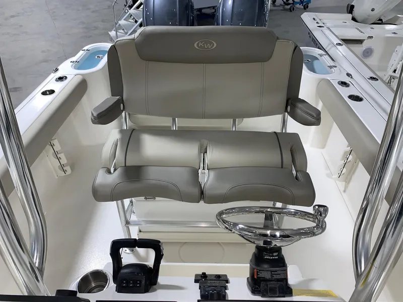 Slide: The Image of 2024 Key West 244 Center Console boat interior with dual seating and steering wheel. - 13