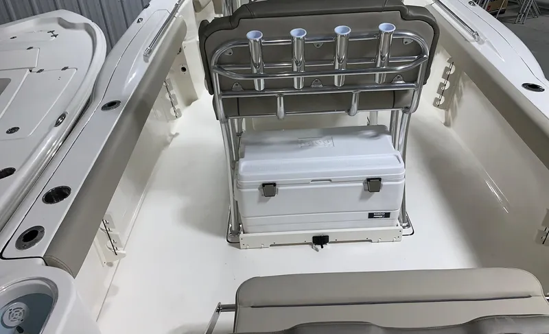 Slide: The Image of 2024 Key West 244 Center Console boat interior with rod holders and cooler. - 5