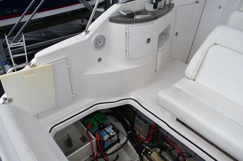 Slide: The Image of 2005 Regal Commodore 2665 boat interior with open engine compartment and seating area. - 13