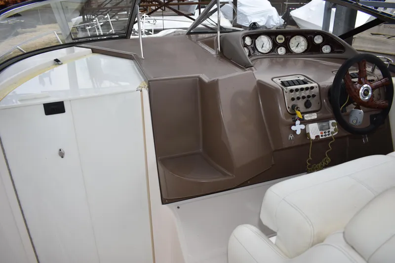 Slide: The Image of 2005 Regal Commodore 2665 boat cockpit with steering wheel and control panel. - 22