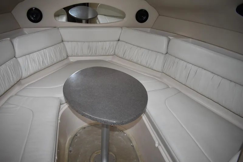 Slide: The Image of Interior of 2005 Regal Commodore 2665 boat with white seating and oval table. - 35