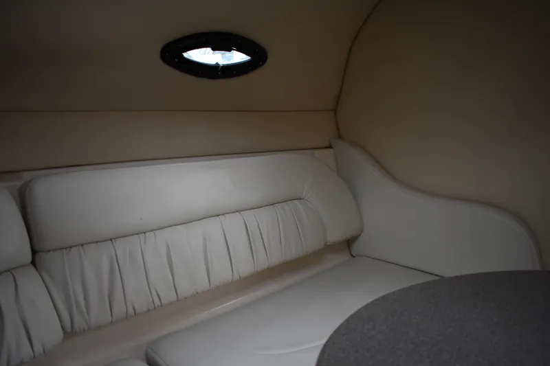 Slide: The Image of Interior cabin of 2005 Regal Commodore 2665 boat with beige seating and small window. - 40