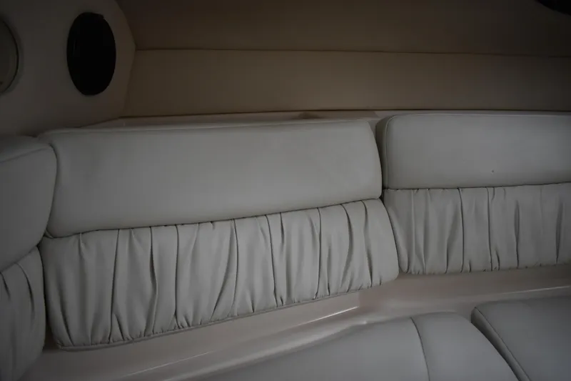 Slide: The Image of Interior seating of 2005 Regal Commodore 2665 boat, featuring plush, light-colored upholstery. - 41