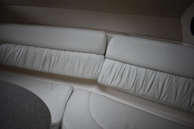 Slide: The Image of Interior seating of 2005 Regal Commodore 2665 boat, featuring white leather upholstery. - 44