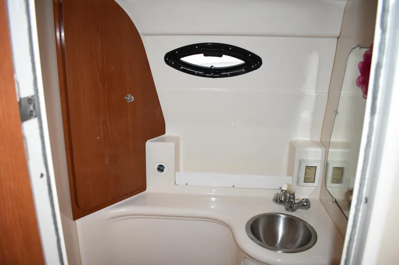 Slide: The Image of 2005 Regal Commodore 2665 boat bathroom with sink and wooden cabinet. - 46