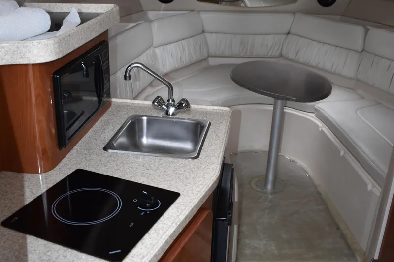 Slide: The Image of 2005 Regal Commodore 2665 interior with kitchenette, sink, and seating area. - 48
