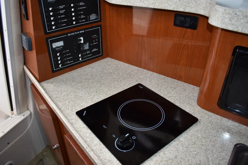 Slide: The Image of 2005 Regal Commodore 2665 boat interior with stove and control panels. - 49