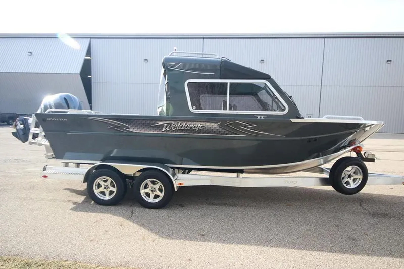 Slide: The Image of 2023 Weldcraft 210 Revolution F200XB boat on trailer, side view. - 17