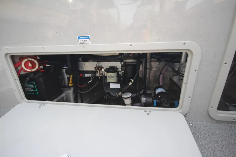 Slide: The Image of 2023 Weldcraft 210 Revolution F200XB engine compartment with various mechanical components. - 23