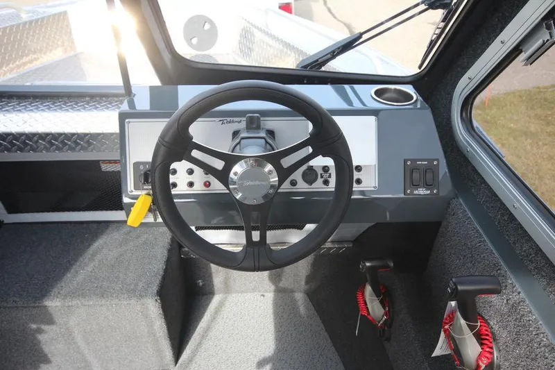 Slide: The Image of 2023 Weldcraft 210 Revolution F200XB boat dashboard and steering wheel. - 29