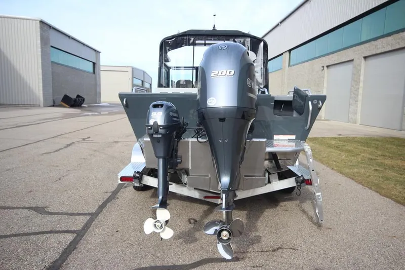 Slide: The Image of 2023 Weldcraft 210 Revolution F200XB boat, rear view with dual outboard motors. - 32